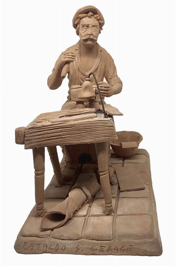 Monochrome terracotta figurine depicting a cobbler at work