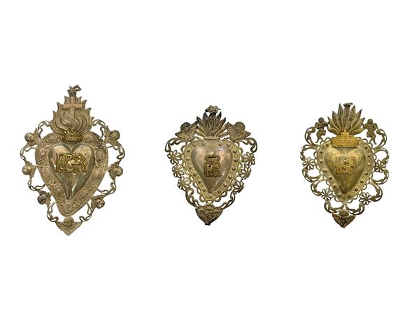 N 3 Ex-voto silver vermeil vote partly in a heart shape with putti and symbols of passion. 1) H 23 cm 2) H 17 cm 3) H 20 cm