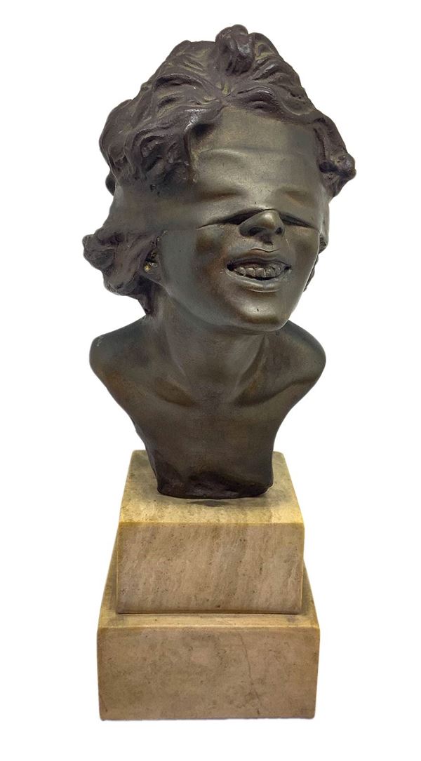 Bronze statue depicting a blindfolded girl, on a marble base.