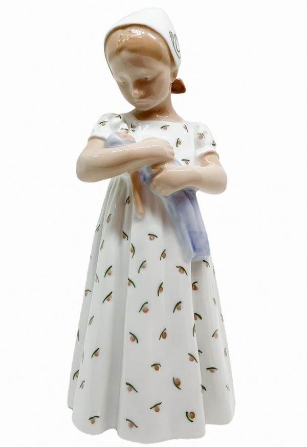 Copenhagen porcelain figurine depicting a child with doll. H 20 cm