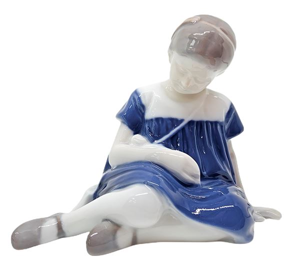 Copenhagen porcelain figurine depicting little girl sitting with doll
