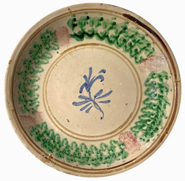 Majolica plate from Caltagirone, 20th century. Decorated with flower. Cm 33