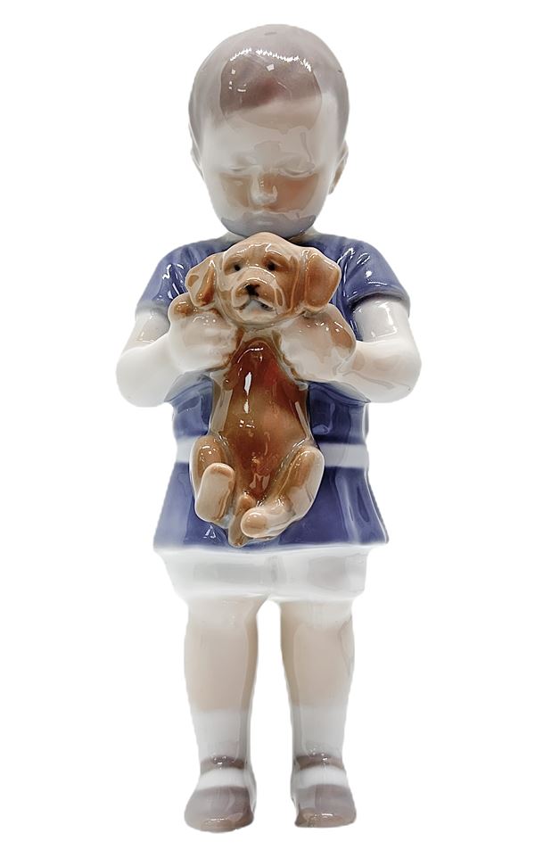Copenhagen porcelain figurine depicting child with puppy dog. H 17.5 cm