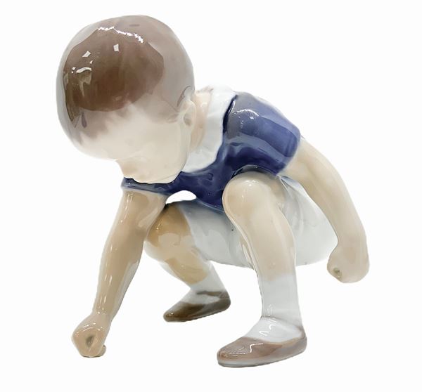 Copenhagen porcelain figurine depicting child who picks up an object. H 10x10 cm