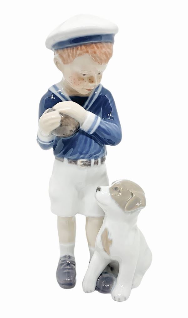 Copenhagen porcelain figurine depicting sailor boy and puppy. H 17 cm